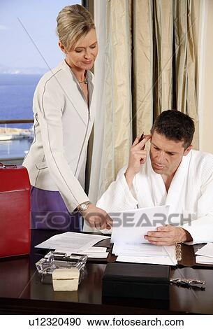 Two business people working in a hotel room View Large Photo Image Stock Image - Two business people working in a hotel room. Fotosearch