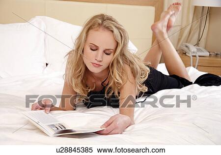 Woman relaxing in bed View Large Photo Image Stock Photography - Woman relaxing in bed. Fotosearch