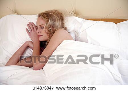 Stock Photo - Woman sleeping in bed. Fotosearch