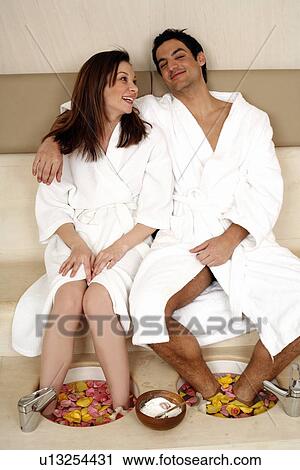 A young couple enjoying a foot bath with rose petals View Large Photo Image Stock Image - A young couple enjoying a foot bath with rose petals. Fotosearch