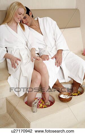 A young couple enjoying a foot bath with rose petals View Large Photo Image Stock Image - A young couple enjoying a foot bath with rose petals. Fotosearch