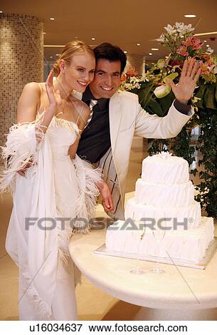 Bride and groom cutting their cake View Large Photo Image Stock Photo - Bride and groom cutting their cake. Fotosearch