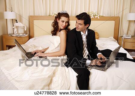 Bride and groom on laptops View Large Photo Image Stock Photo - Bride and groom on laptops. Fotosearch