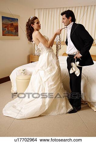 Bride and groom undressing in hotel room View Large Photo Image Picture - Bride and groom undressing in hotel room. Fotosearch