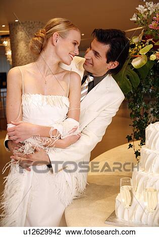 Bride and groom with cake View Large Photo Image Stock Image - Bride and groom with cake. Fotosearch