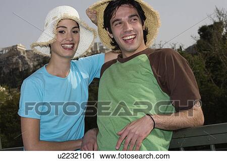 Stock Image - Couple at archaeological site posing with hats. Fotosearch