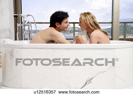 Stock Photo - Couple enjoying bubble bath together. Fotosearch