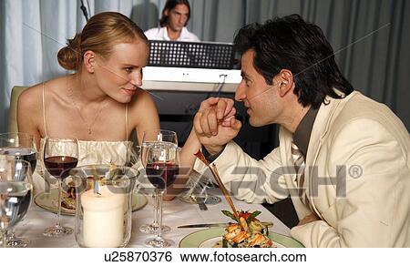 Stock Photograph - Couple having a romantic dinner in a restaurant. Fotosearch