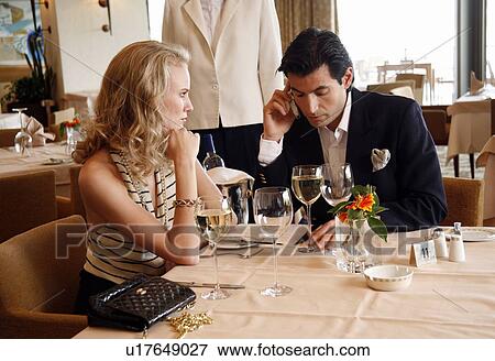 Stock Photo - Couple having a romantic moment in a restaurant. Fotosearch
