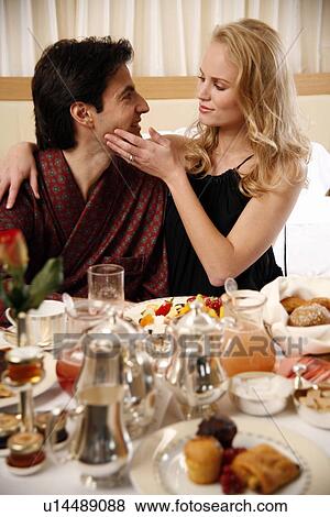 Stock Photo - Couple having room service breakfast in hotel room. Fotosearch