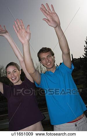 Couple with hands up View Large Photo Image Stock Photo - Couple with hands up. Fotosearch