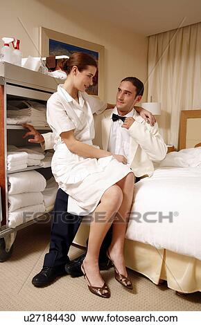 Hotel maid and waiter taking a break View Large Photo Image Stock Image - Hotel maid and waiter taking a break . Fotosearch