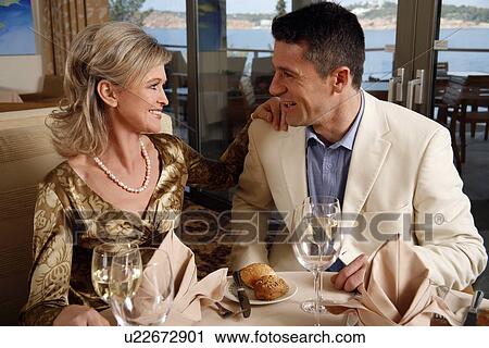Stock Image - Mature couple dining in a restaurant. Fotosearch