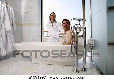 Picture - Mature couple having fun in the bathtub. Fotosearch