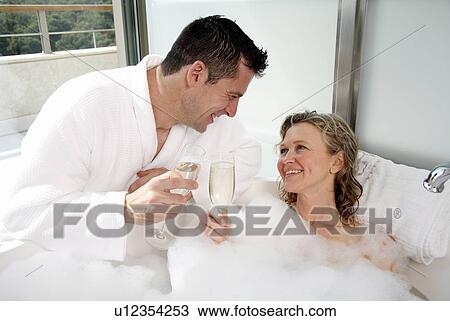 Stock Image - Mature couple having fun in the bathtub. Fotosearch