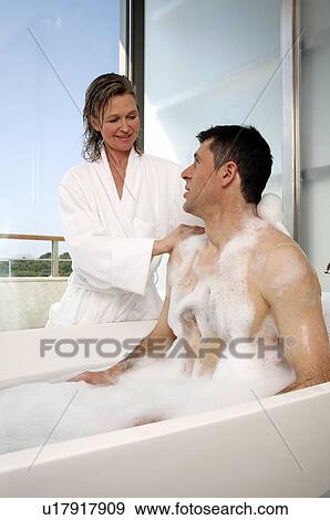 Stock Photo - Mature couple having fun in the bathtub. Fotosearch
