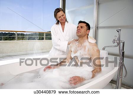 Stock Photo - Mature couple having fun in the bathtub. Fotosearch