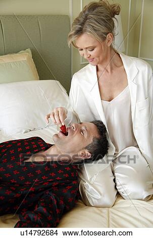 Picture - Mature couple having room service breakfast. Fotosearch