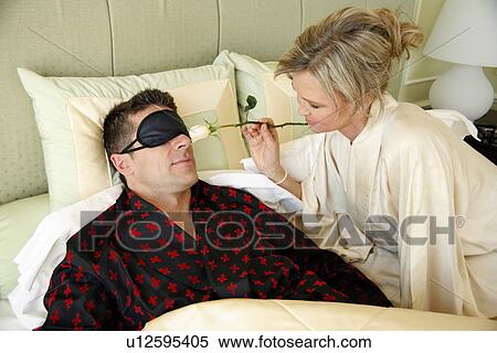 Mature couple relaxing in bed View Large Photo Image Stock Photography - Mature couple relaxing in bed. Fotosearch