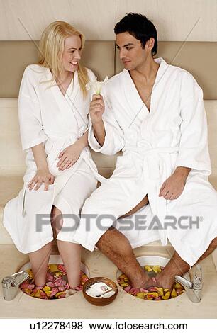 A young couple enjoying a foot bath with rose petals View Large Photo Image Stock Photo - A young couple enjoying a foot bath with rose petals. Fotosearch