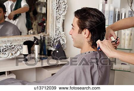 Young man having a haircut View Large Photo Image Stock Photo - Young man having a haircut. Fotosearch