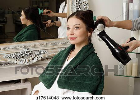 Young woman having her hair curled View Large Photo Image Stock Photo - Young woman having her hair curled. Fotosearch