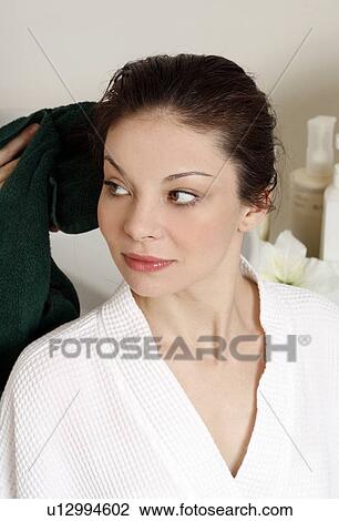 Stock Image - Young woman having her hair washed at a salon. Fotosearch