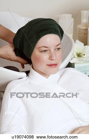 Young woman having her hair washed at a salon View Large Photo Image Stock Photo - Young woman having her hair washed at a salon. Fotosearch