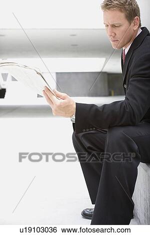 A Mid Adult Businessman Sitting Down and Reading a Newspaper, Full Length View Large Photo Image Stock Photograph - A Mid Adult Businessman Sitting Down and Reading a Newspaper, Full Length. Fotosearch