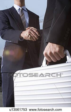 A Pair of Businessman Shaking Hands, Low Angle View, Lens Flare View Large Photo Image Stock Image - A Pair of Businessman Shaking Hands, Low Angle View, Lens Flare. Fotosearch