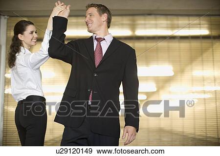 A Pair of Office Workers Touching Each Other's Hand, Three Quarter Length, Waist Up, Differential Focus View Large Photo Image Stock Photo - A Pair of Office Workers Touching Each Other's Hand, Three Quarter Length, Waist Up, Differential Focus. Fotosearch