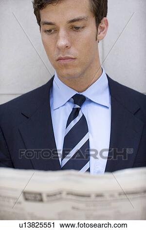 A Young Adult Businessman Reading a Newspaper, Front View, Head and Shoulders, Differential Focus View Large Photo Image Stock Image - A Young Adult Businessman Reading a Newspaper, Front View, Head and Shoulders, Differential Focus. Fotosearch