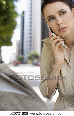 A Young Adult Businesswoman Talking on a Cellular Phone, Front View, Waist Up, Differential Focus View Large Photo Image Stock Photo - A Young Adult Businesswoman Talking on a Cellular Phone, Front View, Waist Up, Differential Focus. Fotosearch
