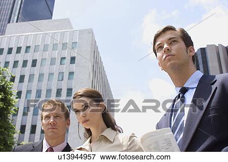Three Office Workers in Downtown Looking Away, Low Angle View, Head and Shoulders View Large Photo Image Stock Photo - Three Office Workers in Downtown Looking Away, Low Angle View, Head and Shoulders. Fotosearch