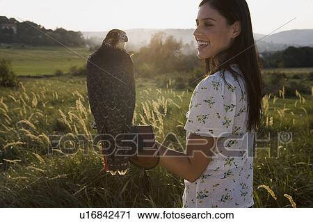 Woman holding bird. View Large Photo Image Stock Image - Woman holding bird.. Fotosearch