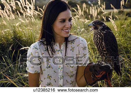 Woman holding bird. View Large Photo Image Stock Photograph - Woman holding bird.. Fotosearch