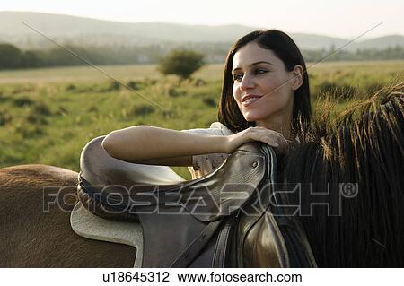 Stock Image - Woman standing with horse.. Fotosearch