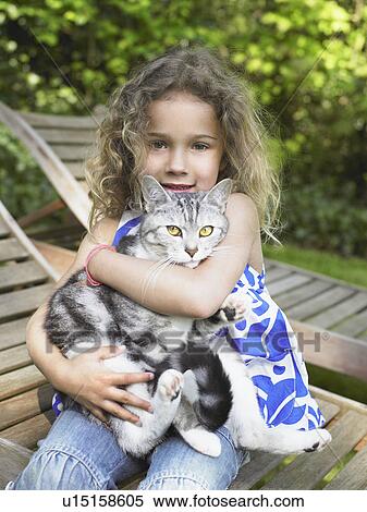 Young girl outdoors smiling with a cat on her lap. View Large Photo Image Stock Photography - Young girl outdoors smiling with a cat on her lap.. Fotosearch
