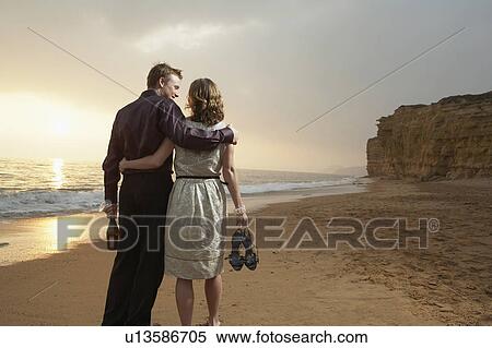 Couple walking together on beach. View Large Photo Image Stock Photography - Couple walking together on beach.. Fotosearch