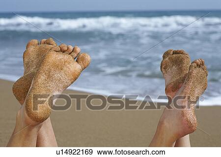Stock Photo - Pair of sandy feet on beach.. Fotosearch