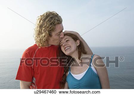 Portrait of a young man kissing a Woman. View Large Photo Image Stock Image - Portrait of a young man kissing a Woman.. Fotosearch