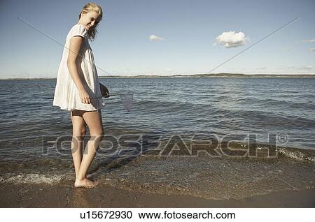 Young woman at beach. View Large Photo Image Stock Image - Young woman at beach.. Fotosearch