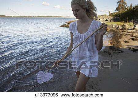 Young woman at beach. View Large Photo Image Stock Photograph - Young woman at beach.. Fotosearch
