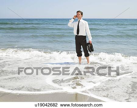 Stock Image - Businessman at the beach.. Fotosearch