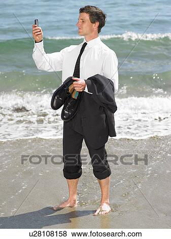 Stock Photo - Businessman at the beach.. Fotosearch