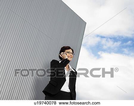 Businesswoman by a silver wall. View Large Photo Image Stock Photo - Businesswoman by a silver wall.. Fotosearch