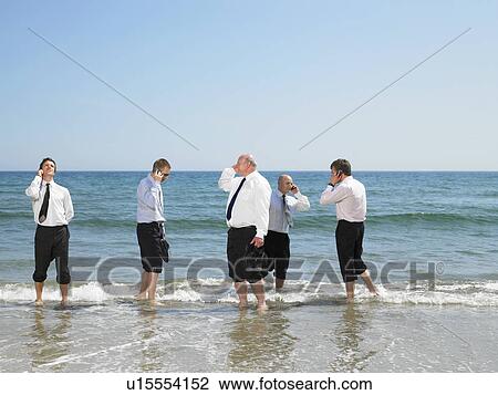 Group of businesspeople on the beach. View Large Photo Image Stock Image - Group of businesspeople on the beach.. Fotosearch