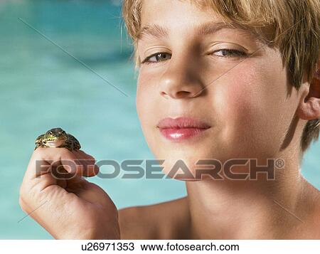 Boy holding a frog in his hand. View Large Photo Image Stock Image - Boy holding a frog in his hand.. Fotosearch