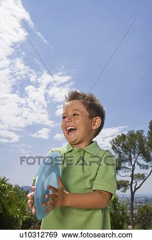 Stock Photo - Boy holding Frisbee.. Fotosearch