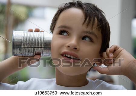 Boy using a tin can as a phone. View Large Photo Image Stock Photo - Boy using a tin can as a phone.. Fotosearch